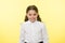 So cute. Girl school uniform smiling cheerful face yellow background. Child ready back to school end continue education