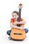 Cute girl sitting with acoustic guitar.