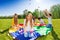 Cute girl sitting on parachute with colorful balls