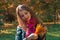 Cute girl smiling keeps the leaves drooping head in the Park