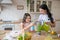 Cute girl spraying the flowers with water and smiling