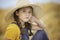 Cute girl in a straw hat, sitting in a field of hay in Eagle Mountain, Ut.