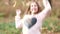 Cute girl throwing leaves in park