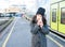 Cute girl waiting next to a train and wiping her tears