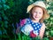 Cute girl watering herbs. Child taking care of plants. Kid with