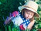 Cute girl watering herbs. Child taking care of plants. Kid with