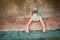 Cute girl wets hands in a fountain Valldemossa