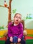 Cute girl in wheelchair in kindergarten for children with special needs