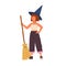 Cute girl in witch hat standing with a broomstick. Portrait of funny little wizard or sorcerer holding magic broom