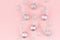 Cute girlish glamour christmas background - bright silver balls, snowflakes as pattern on pastel pink background, top view.