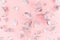 Cute girlish new year background - elegant silver branches and leaves on pastel pink paper, top view.