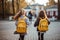 cute girls children, backpacks on their shoulders, joyfully walking towards school.