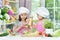 Cute girls preparing delicious fresh salad in kitchen