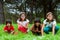 Cute girls sitting in green grass field.