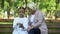 Cute granddaughter teaching granny how to use modern smartphone, generation gap