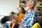 Cute grandfather and beautiful grandchildren reading a book