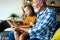 Cute grandfather and beautiful grandchildren reading a book