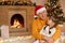 Cute grandfather hugging her grandchild while sitting on floor near fireplace, family at home, celebrating new year eve, looking