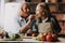 Cute Grandma and Granddaughter Cutting Vegetables