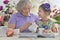 Cute grandmother with a granddaughter drinking tea