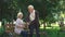 Cute grandparents admiring their grandchildren running in park, family weekend