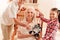 Cute grandparents and child posing with robot toy