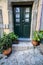 Cute green door entryway with potted plants in Porto, Portugal