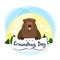 Cute groundhog. Cute marmot. Greeting Card Groundhog Day. Sun, clouds, trees.