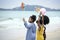 Cute groups of kids have fun together on sandy summer beach with blue sea, happy childhood friends play on tropical beach,