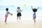 Cute groups of kids having fun together on sandy summer beach with blue sea, happy childhood friends playing ball on tropical