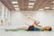 Cute gymnast engaged in training in the hall, stretching on the Mat