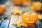 Cute Halloween carved pumpkin glowing with autumn leaves