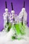 Cute Halloween green drinks for a kids party in spider cobweb on traditional purple background, funny food for seasonal autumn