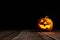 Cute Halloween pumpkin head jack lantern on wooden background