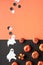 Cute Halloween vertical background, template for social media stories. Black and orange flat lay with painted deco