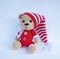 Cute handmade crochet bear doll on white background with shadow reflection.