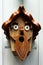 Cute handmade wooden birdhouse in the shape of a funny bearded man with his mouth open