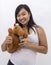 Cute happy asian girl with a teddy horse smiling