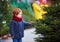 Cute happy baby boy choosing the christmas tree for winter holidays at seasonal market