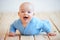 Cute happy baby boy crawling on the floor