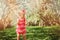 Cute happy baby girl in funny pink romper walking outdoor in spring garden