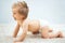 Cute, happy blonde baby boy in diapers playing and posing on Fur Wool Carpet Rugs
