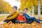Cute happy children, siblings, boys, playing with knitted toys in the park, autumntime
