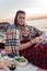 Cute happy couple having romantic dinner with grapes and cheese on beach