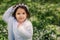 Cute happy dreamy toddler child girl walking in blooming spring garden, celebrating easter outdoor