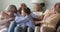 Cute happy females relatives of diverse age tickling on sofa