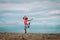 Cute happy girl dance, child play at summer beach