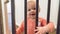 Cute happy little baby peering through rails