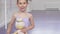 Cute happy little ballerina girl smiling joyfully holding ballerina doll