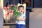 Cute happy little boy holding bouquet of red tulips in his hands greeting mother or sister or grandmother at home. Mothers or Vale